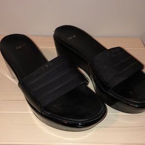 Prada black wedge slides.